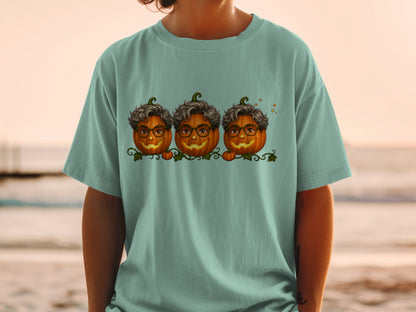 Three pumpkins with curly hair and glasses sit on a vine.