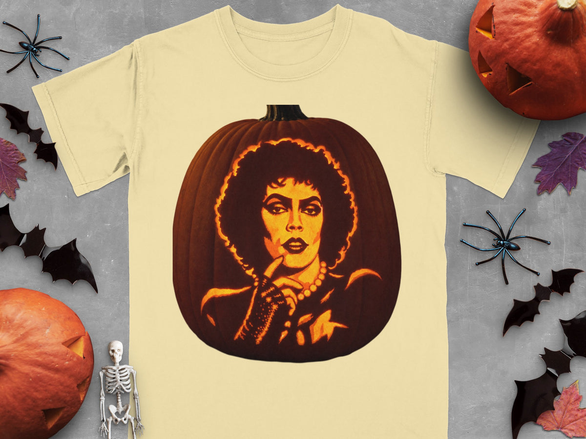 Beige t-shirt featuring a large graphic of a pumpkin carved with a Frank-N-Furter portrait.