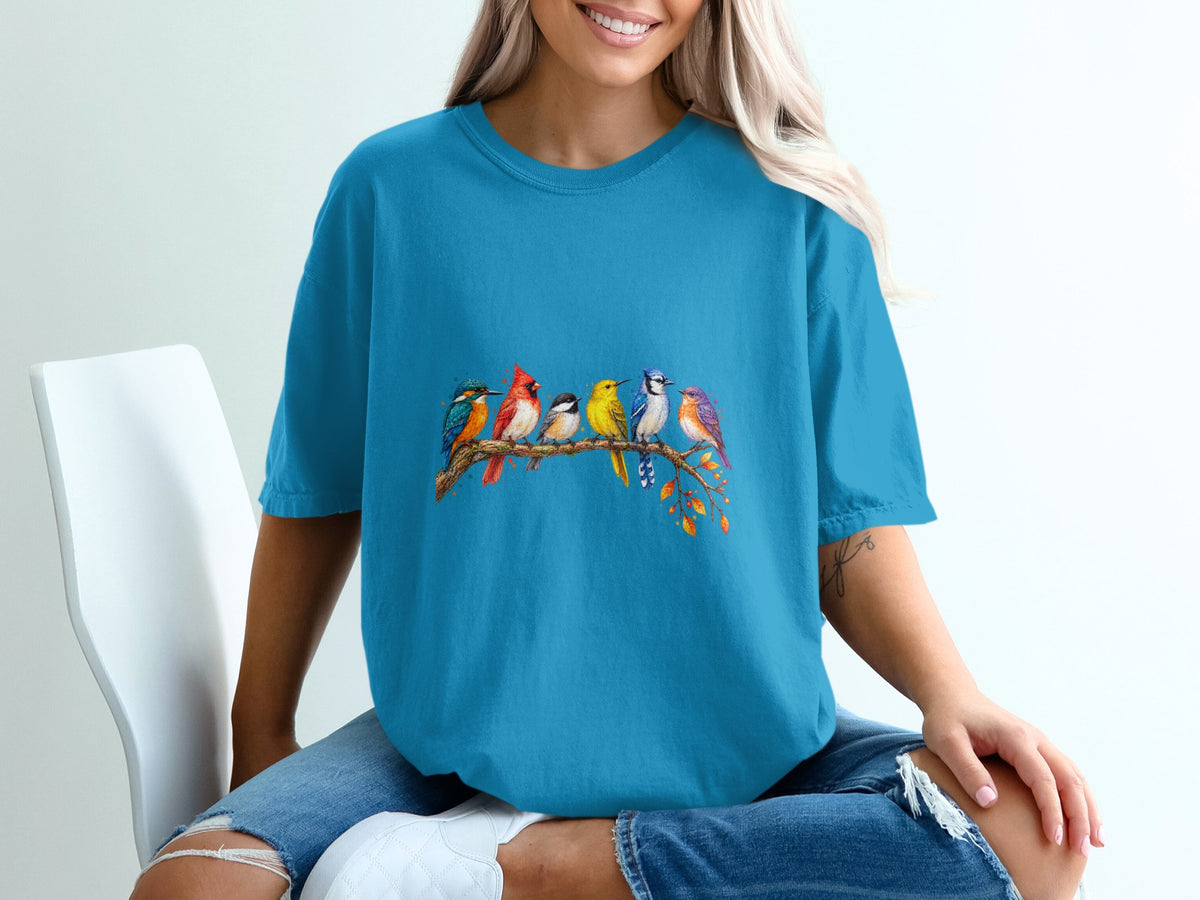 Blue t-shirt with colorful birds perched on a tree branch graphic.