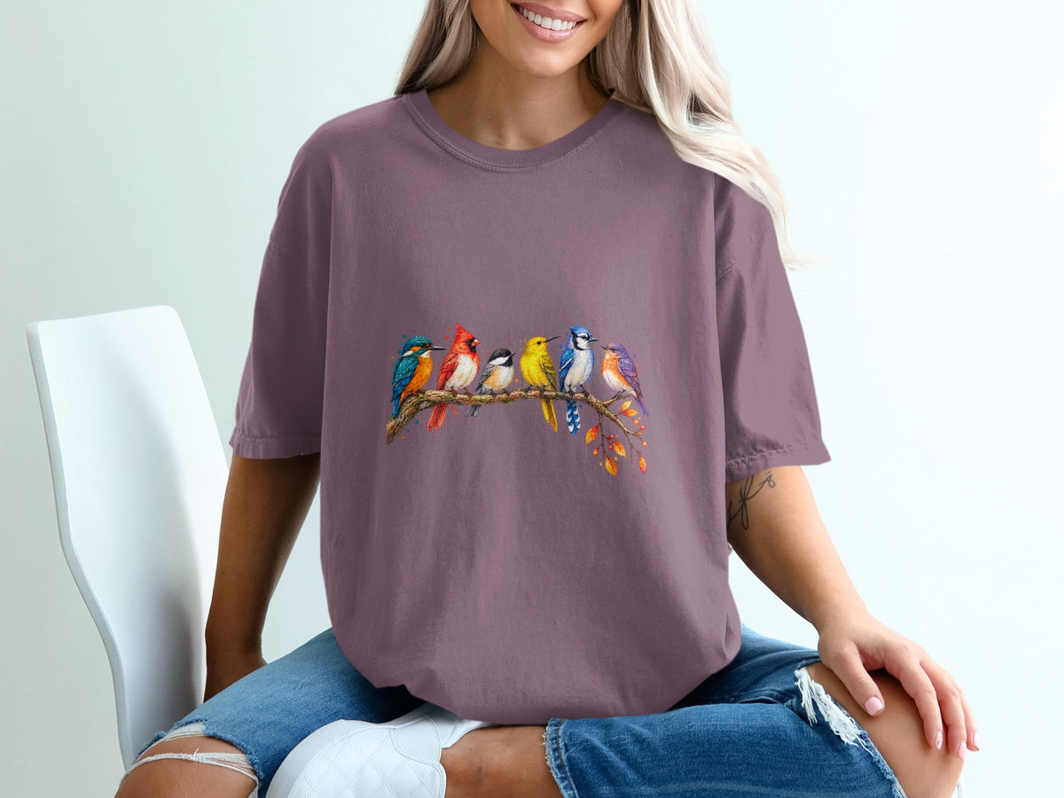 T-shirt with colorful birds perched on a branch with autumn leaves.