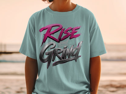 Teal t-shirt with "Rise and Grind" text in pink and metallic grey lettering.