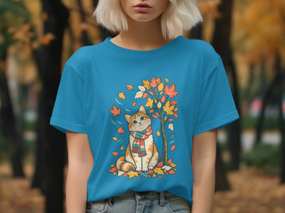 Orange and white cat in scarf sits by tree with colorful autumn leaves.
