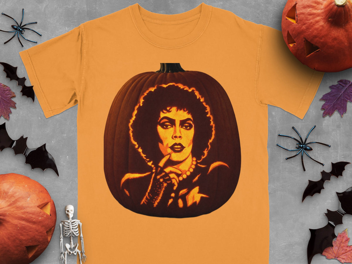 An orange t-shirt features a carved pumpkin graphic of Frank-N-Furter, surrounded by Halloween decorations on gray.
