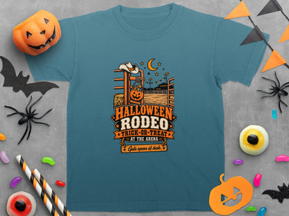 Teal t-shirt with Halloween Rodeo Trick-or-Treat graphic and festive decorations.