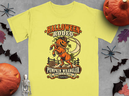 Yellow t-shirt with "Halloween Rodeo Pumpkin Wrangler" graphic featuring a jack-o'-lantern horse.