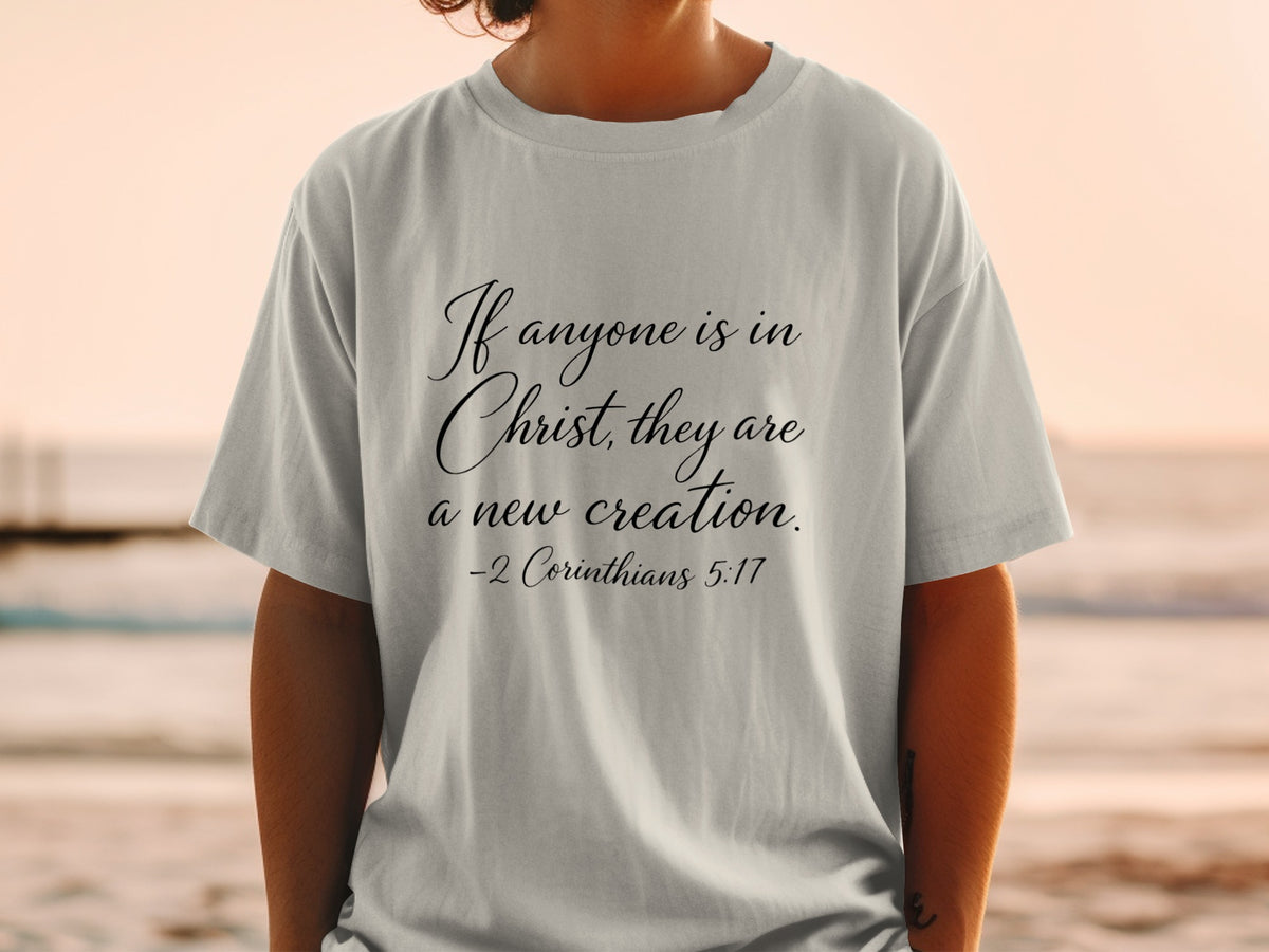Grey t-shirt with "If anyone is in Christ, they are a new creation. -2 Corinthians 5:17" text.