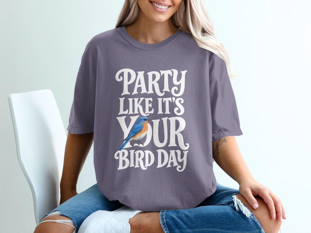 Purple t-shirt with "Party Like It's Your Bird Day" text and blue bird graphic.