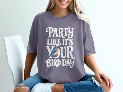 Purple t-shirt with "Party Like It's Your Bird Day" text and blue bird graphic.