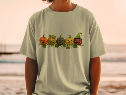 Five smiling jack-o'-lanterns, one wearing a witch hat, arranged on a vine.