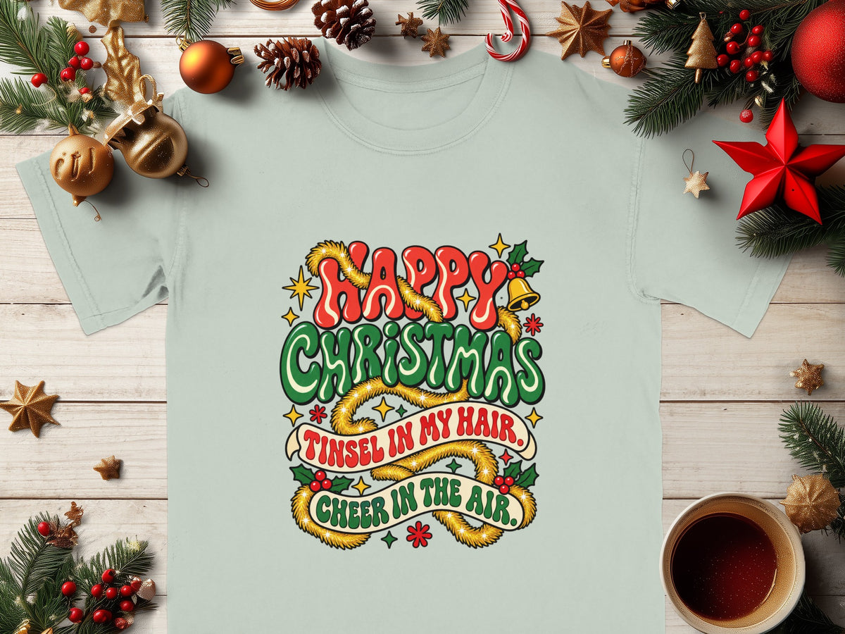 Light blue t-shirt with "Happy Christmas, Tinsel in My Hair, Cheer in the Air" text.