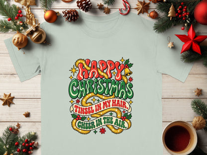 Light blue t-shirt with "Happy Christmas, Tinsel in My Hair, Cheer in the Air" text.