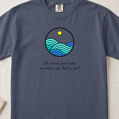 Blue t-shirt with circular ocean wave graphic and "The ocean and some sunshine can heal a soul" text.