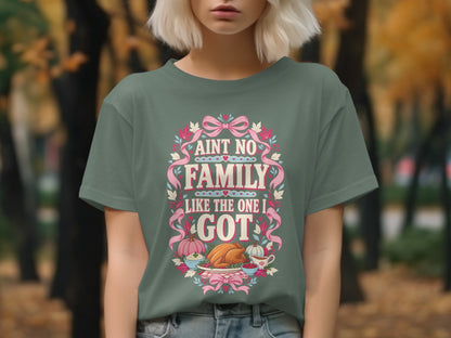 T-shirt with "Ain't no family like the one I got" Thanksgiving graphic.