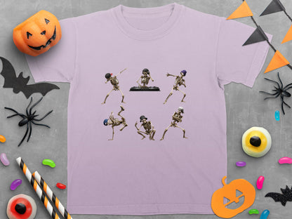 Skeleton dancers in various poses on a light purple t-shirt with Halloween decorations.