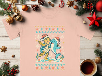 Turtle and dolphin wearing Santa hats embrace in a Christmas sweater design.