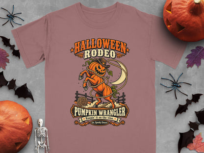 Halloween Rodeo graphic with pumpkin wrangler, moon, and fence.