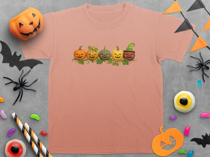 Peach t-shirt with five smiling pumpkins and a Halloween banner.