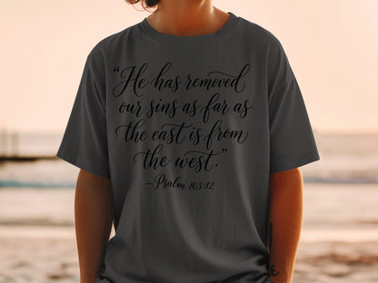 Dark grey t-shirt with "He has removed our sins as far as the east is from the west. -Psalm 103:12".