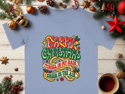 T-shirt with "Happy Christmas, Tinsel in my hair, Cheer in the air" text and festive decorations.