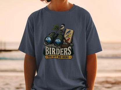 Binoculars and bird illustrations on a shirt with text "BIRDER'S - YOU GOT ME HERE".