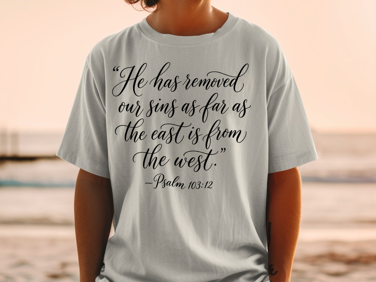 Light grey t-shirt with "He has removed our sins as far as the east is from the west." -Psalm 103:12
