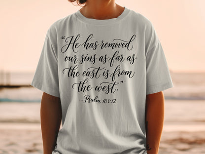 Light grey t-shirt with "He has removed our sins as far as the east is from the west." -Psalm 103:12