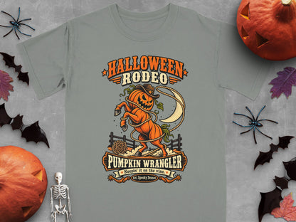 Halloween Rodeo graphic with a pumpkin horse, lasso, and moon. Pumpkin Wrangler text.