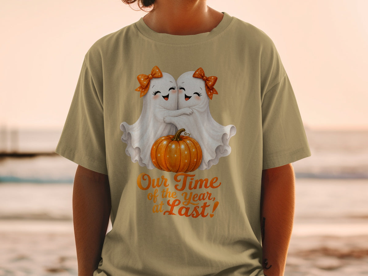 Two cute ghosts hug a pumpkin with text "Our Time of the Year, at Last!"