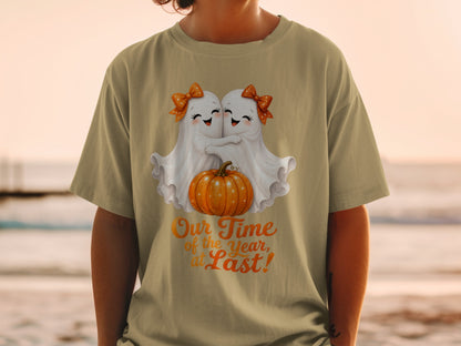 Two cute ghosts hug a pumpkin with text "Our Time of the Year, at Last!"