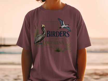 Birders of Louisiana graphic on a maroon t-shirt featuring a pelican and flying bird.