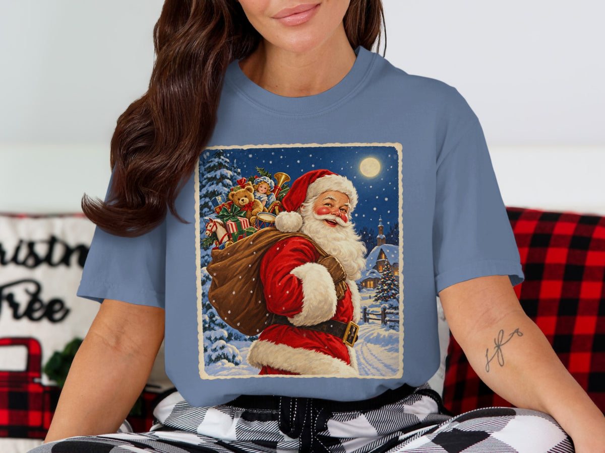 Santa Claus carrying a sack of toys in a snowy village at night.