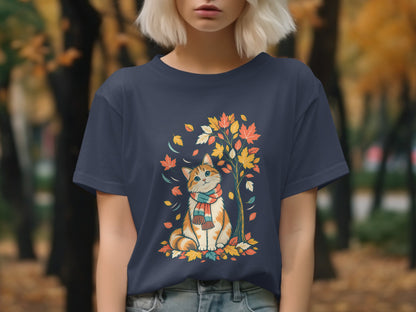 Orange and white cat wearing a scarf, surrounded by autumn leaves and a tree.