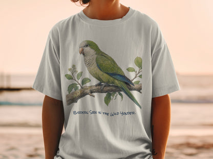 Light grey t-shirt with a green parrot illustration and text "Birder: Seen in the Wild Yonder".