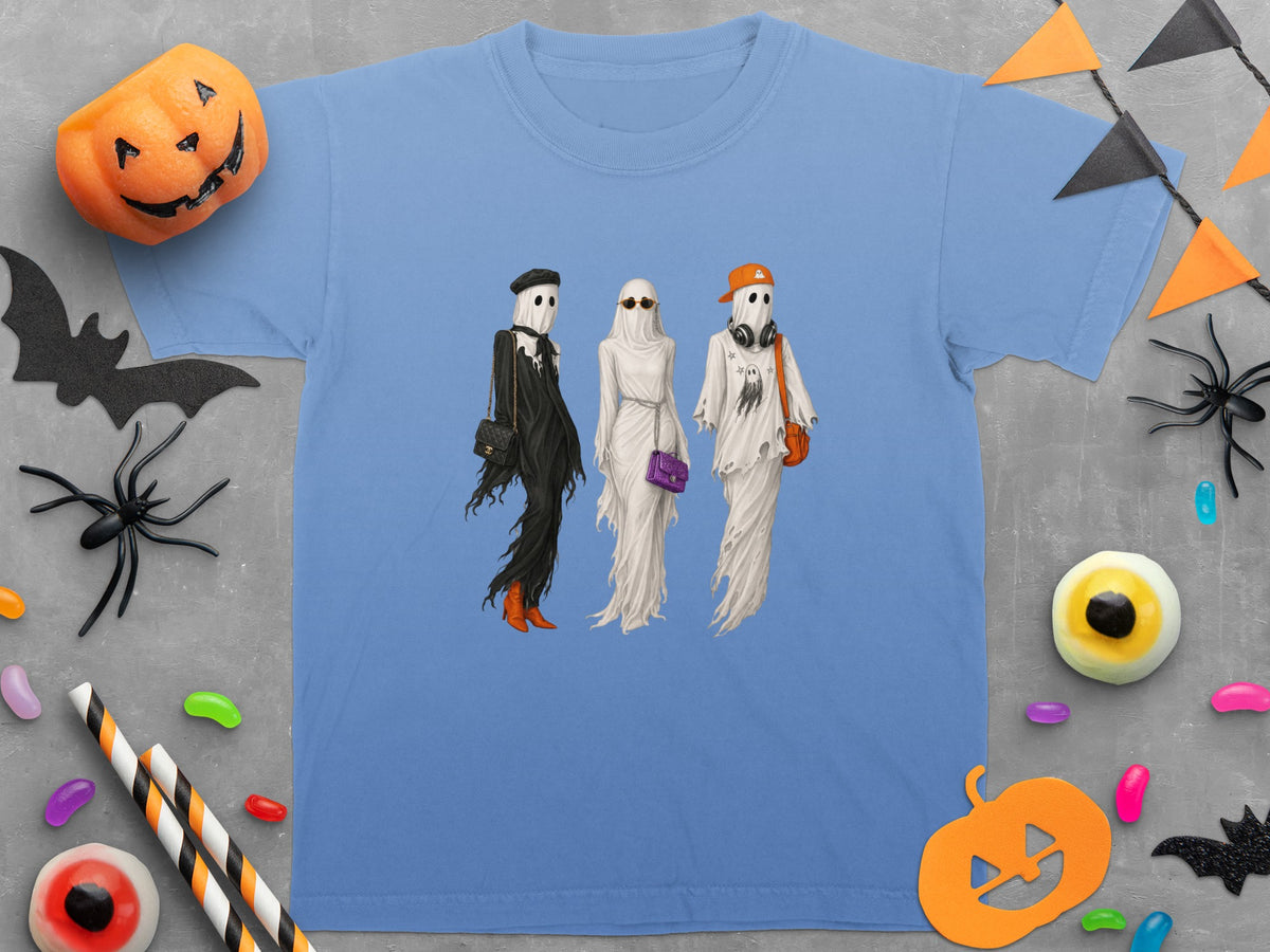 Three ghosts dressed in Halloween outfits with accessories displayed on a t-shirt.