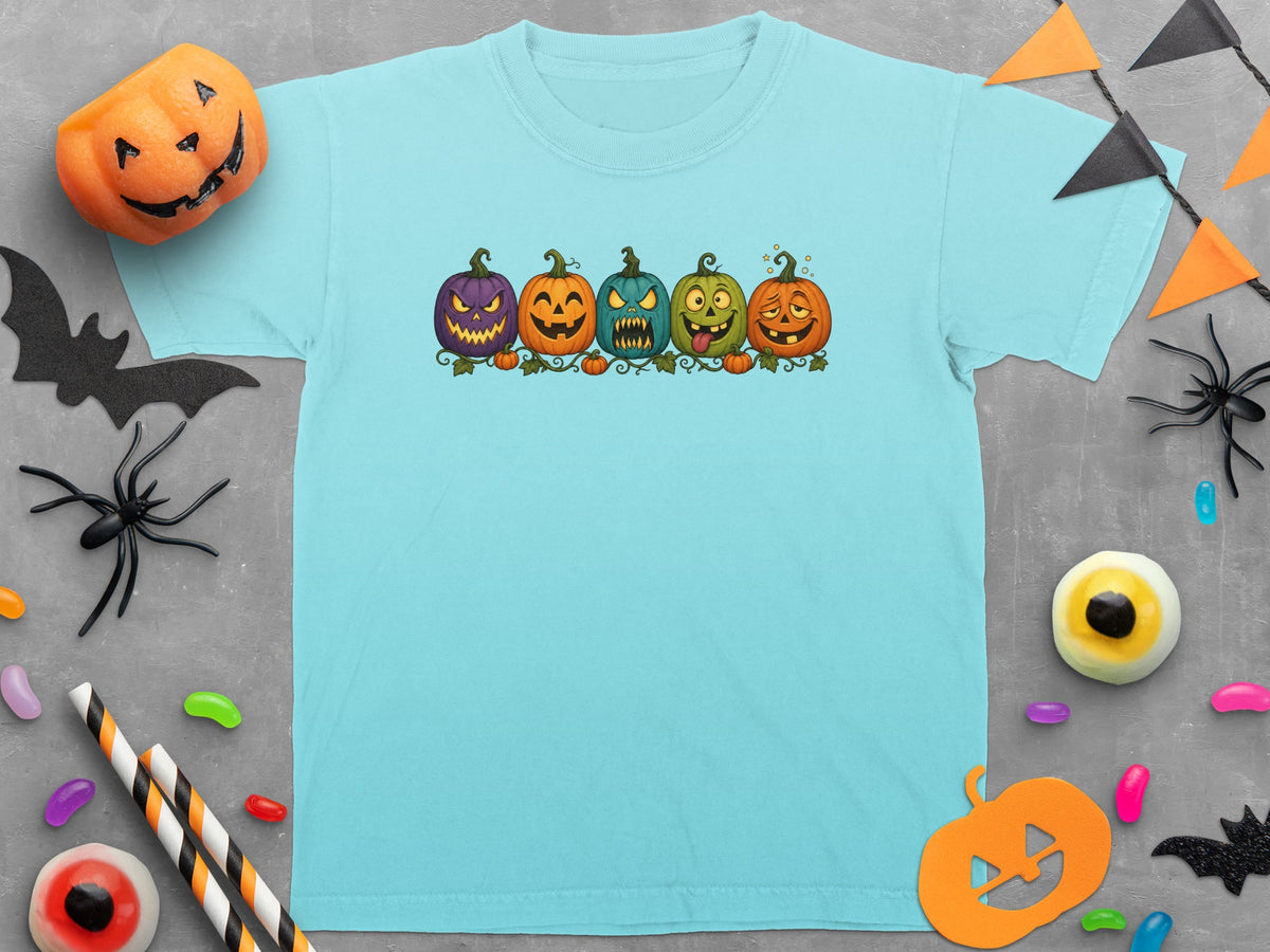 Light blue t-shirt with five cartoon jack-o'-lanterns in a row.