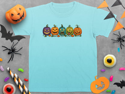Light blue t-shirt with five cartoon jack-o'-lanterns in a row.