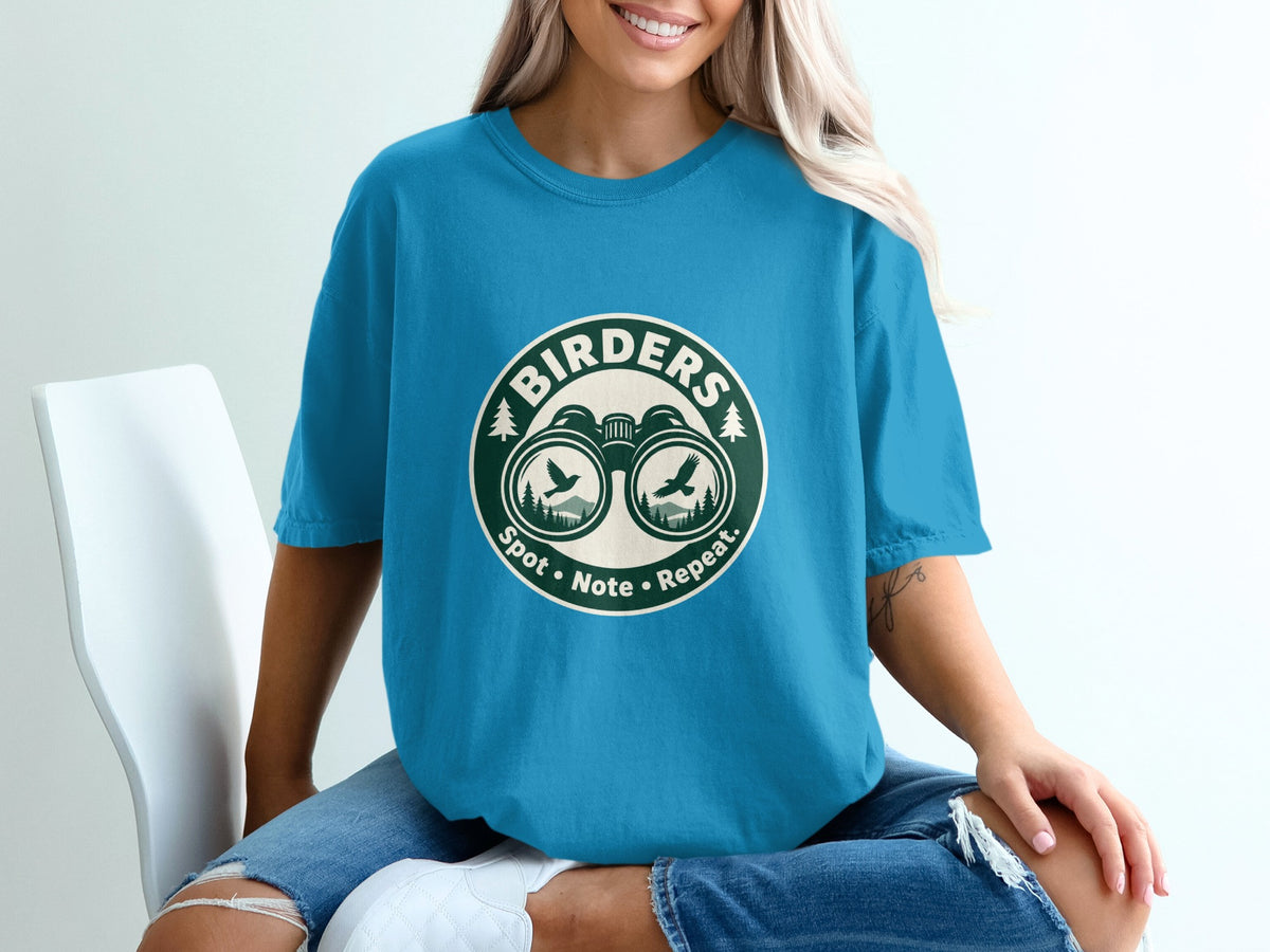 T-shirt with "BIRDERS" logo featuring binoculars, birds, and trees.