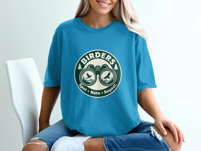 T-shirt with "BIRDERS" logo featuring binoculars, birds, and trees.