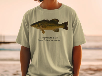 Largemouth Bass State Fish of Alabama graphic on a light tan t-shirt.