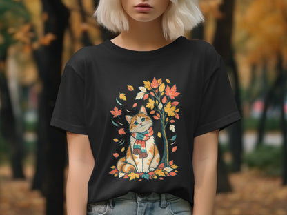 Black t-shirt with a cartoon cat wearing a scarf, sitting among autumn leaves.