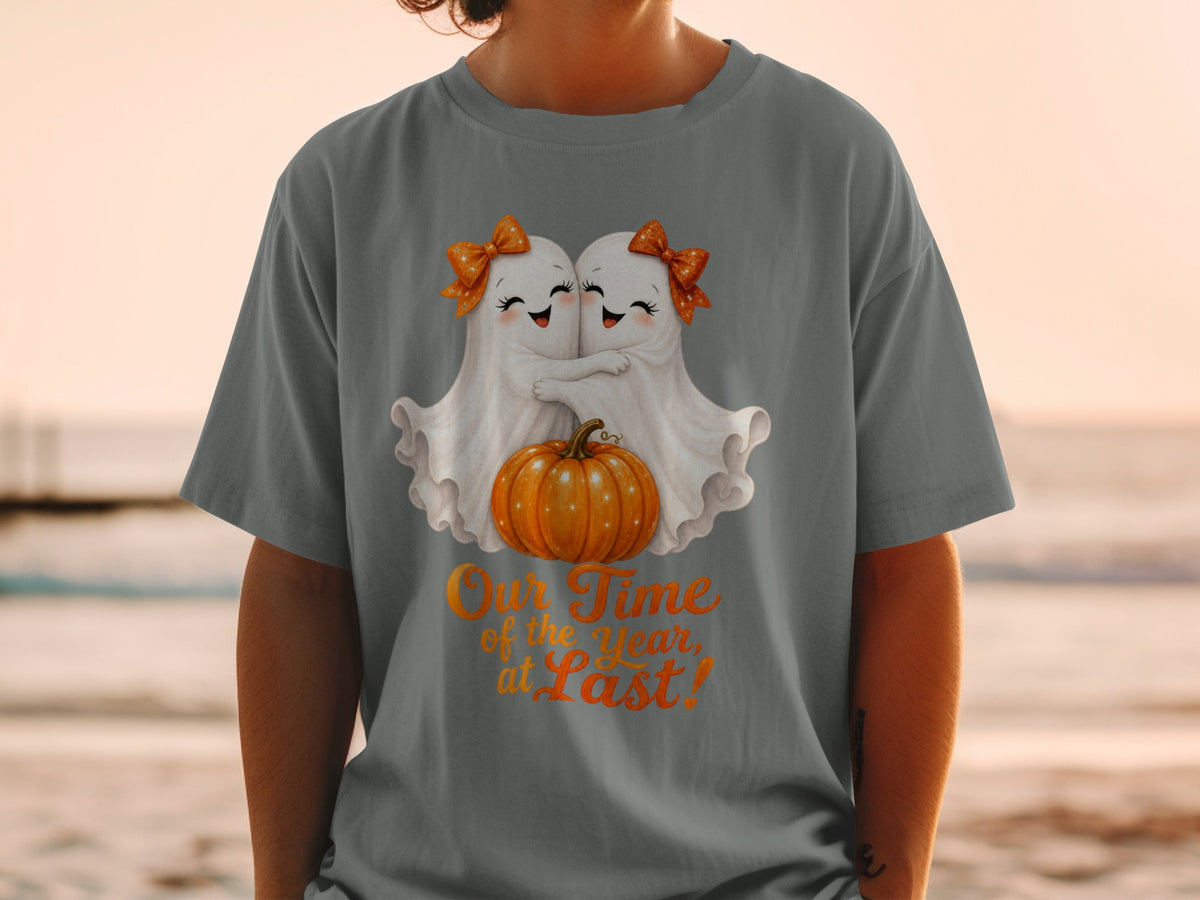T-shirt with two ghosts hugging a pumpkin, text "Our Time of the Year, at Last!".