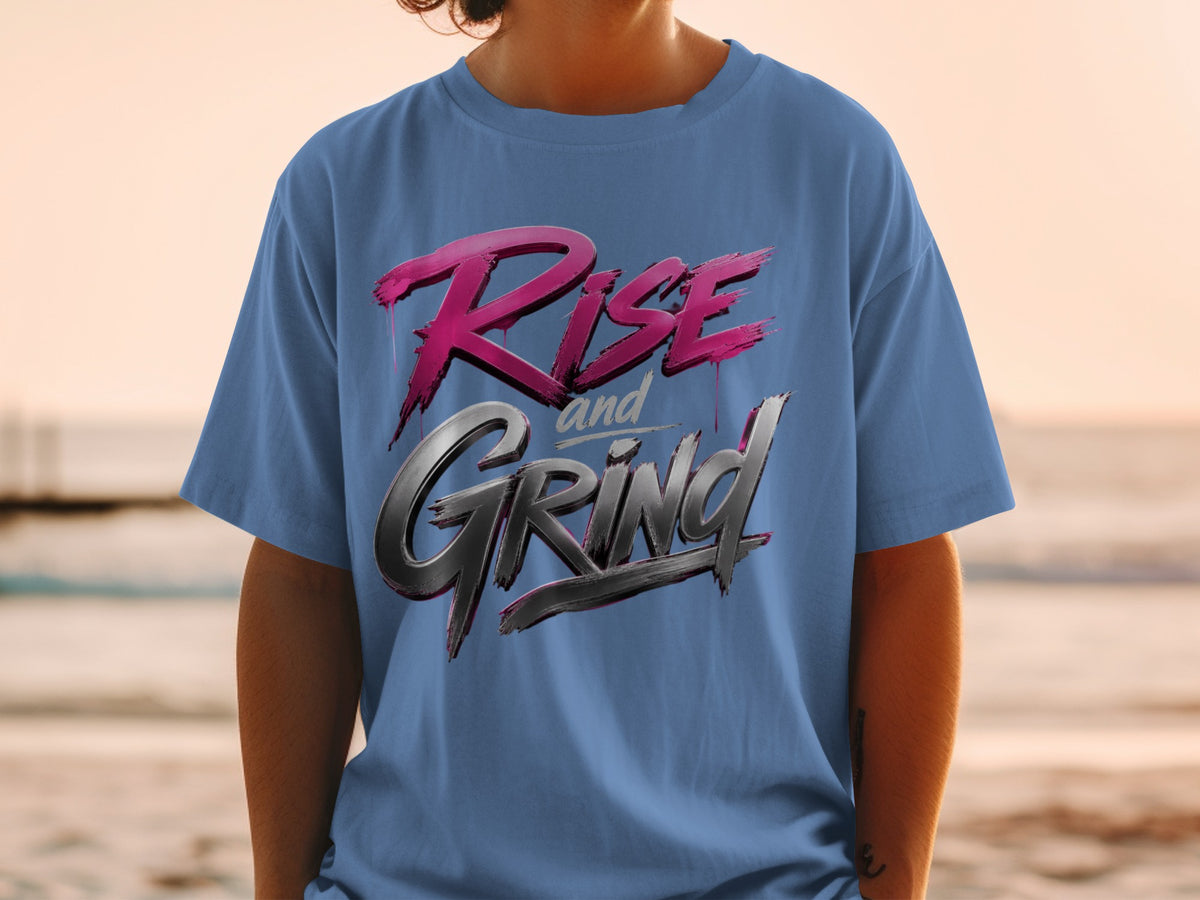 Blue t-shirt with "Rise and Grind" text in stylized pink and silver lettering.