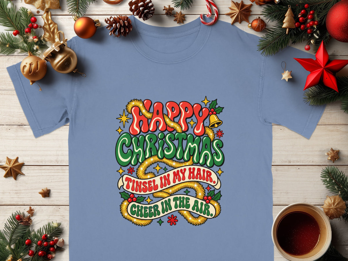 Blue t-shirt with "Happy Christmas, Tinsel in my hair, Cheer in the air" text.
