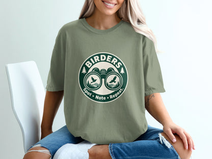 T-shirt with "BIRDERS" logo featuring binoculars, birds, and text "Spot • Note • Repeat."