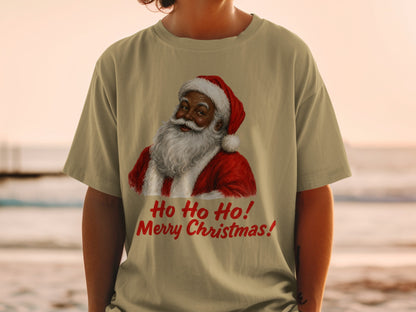 Santa Claus graphic with "Ho Ho Ho! Merry Christmas!" text on a tan t-shirt.