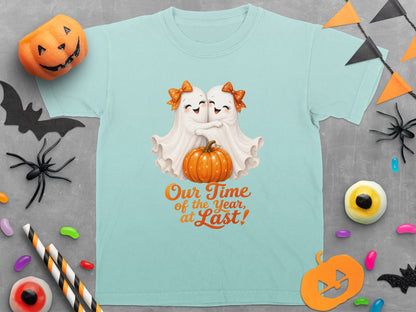 Aqua t-shirt with two ghosts hugging a pumpkin and text "Our Time of the Year, at Last!"