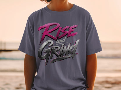Dark gray t-shirt with "Rise and Grind" text in pink and silver metallic font.
