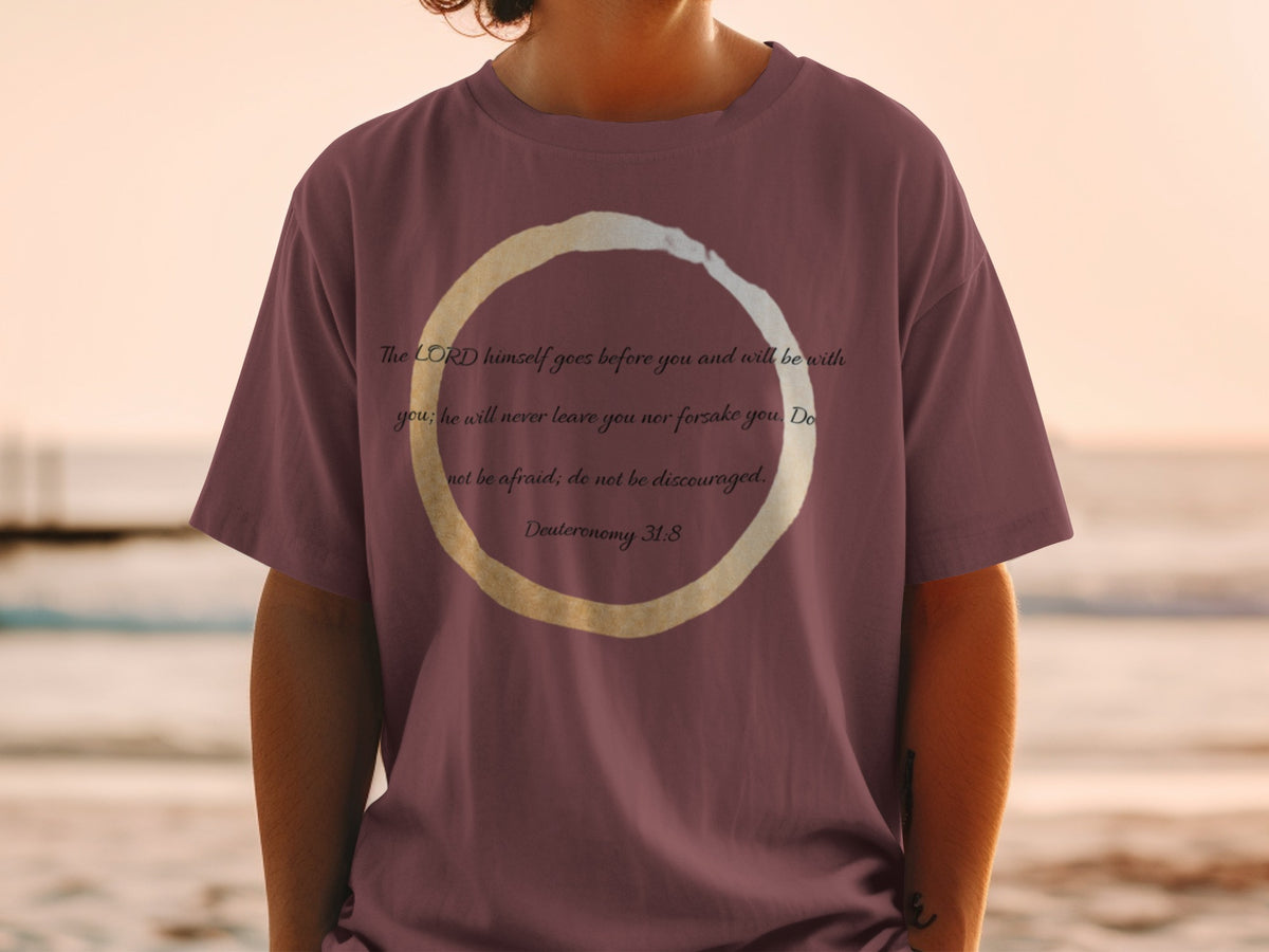Maroon t-shirt with text from Deuteronomy 31:8 and a circular design.