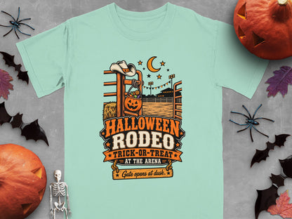 Pale mint t-shirt with "Halloween Rodeo Trick-or-Treat At The Arena Gate opens at dusk" text.