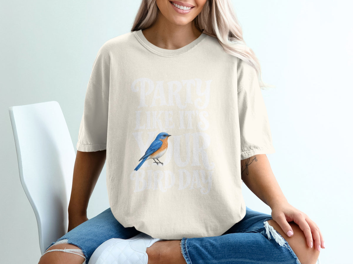 Light beige t-shirt with white text "PARTY LIKE IT'S YOUR BIRD DAY" and a bluebird graphic.
